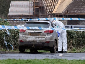 A forensic officer from Police Service of Northern Ireland (PSNI) works at the scene of the Youth Sport Omagh sports complex where off-duty PSNI Detective Chief Inspector John Caldwell was shot, in Omagh, Northern Ireland, Feb. 23, 2023.
