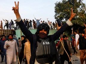 A supporter of former Pakistan Prime Minister Imran Khan gestures during a clash outside the Federal Judicial Complex in Islamabad, Saturday, March 18, 2023.