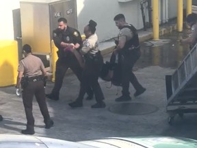 Framegrab of passenger removed from flight at Miami Int'l airport.