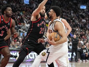 Toronto Raptors forward O.G. Anunoby (3) and guard Fred VanVleet (23) defend against Denver Nuggets guard Jamal Murray (27) during the second half at Scotiabank Arena.