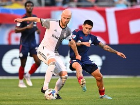 Jul 13, 2022; Chicago, Illinois, USA;  Toronto FC midfielder Michael Bradley (4) and Chicago Fire FC midfielder Federico Navarro (31) battle for control of the ball in the first half at Soldier Field.