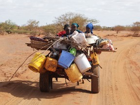 Internally displaced Somali children ride on a donkey cart as they flee from the severe droughts, near Dollow, Gedo Region, Somalia May 26, 2022.