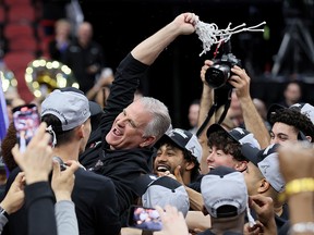 Head coach Brian Dutcher of the San Diego State Aztecs celebrates with the team after defeating the Creighton Bluejays in the Elite Eight at KFC YUM! Center on March 26, 2023 in Louisville, Kentucky.
