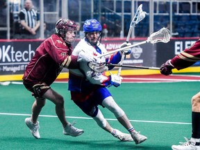 Dan Craig of the Rock looks for an offensive opportunity while Albany’s Jackson Reid defends during a National Lacrosse League game on March 25, 2023, in Albany, N.Y.
