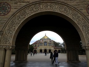 Students and visitors walk on the Stanford University campus on March 12, 2019 in Stanford, California.