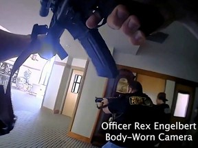 Metropolitan Nashville Police Department Officer Rex Engelbert points his weapon while firing at the mass shooting suspect in The Covenenant School, in a still image from body camera video in Nashville, Tenn., March 27, 2023.