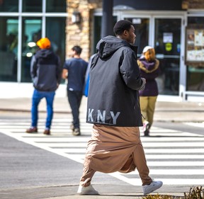 An asylum seeker from Africa, one of thousands of migrants staying in hotels in Niagara Falls, Ont., out for a walk on Friday, March 24, 2023.
