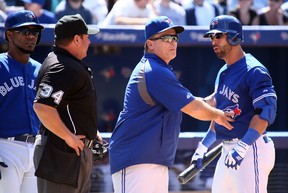 Manager John Gibbons holds back Jose Bautista of the Toronto Blue Jays as he argues a strikeout with umpire Sam Holbrook who ejected him from the game against the Houston Astros during MLB action at the Rogers Centre in Toronto July 28, 2013. Dave Abel/Toronto Sun