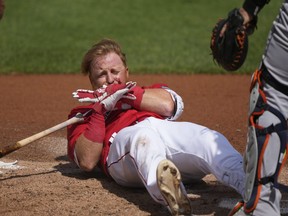 Boston Red Sox Justin Turner reacts after being hit in the face on a pitch by Detroit Tigers starting pitcher Matt Manning in the first inning of their spring training baseball game in Fort Myers, Fla., Monday, March 6, 2023.