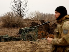 A Ukrainian serviceman waits for the order to fire a M119 howitzer near the frontline town of Ukraine March 8, 2023.