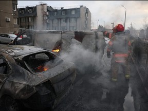 A view of emergency workers at the site of a Russian missile strike, amid Russia's attack on Ukraine, in Kyiv, Ukraine, March 9, 2023.
