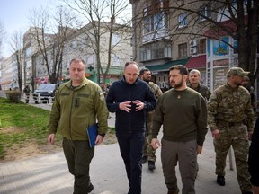 Ukraine's President Volodymyr Zelenskyy walks along a street, amid Russia's attack on Ukraine, as he visits Kherson, Ukraine March 23, 2023.