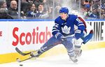 Mar 15, 2023; Toronto, Ontario, CAN; Toronto Maple Leafs forward Joel Acciari (52) takes the puck away from Colorado Avalanche defenseman Brad Hunt (17) in the first period at Scotiabank Arena. 