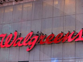 Pigeons are seen resting on signage for Walgreens, owned by the Walgreens Boots Alliance, Inc., in Manhattan, N.Y., Nov. 26, 2021.