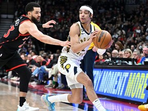 Indiana Pacers guard Andrew Nembhard (2) moves away from Toronto Raptors guard Fred VanVleet (23) in the first half at Scotiabank Arena.