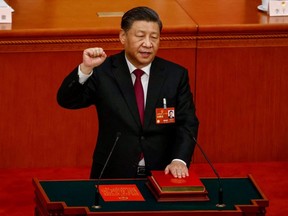 Chinese President Xi Jinping takes his oath during the Third Plenary Session of the National People's Congress at the Great Hall of the People, in Beijing, Friday, March 10, 2023.