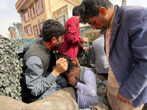 Wounded journalists are shifted on a vehicle to a hospital, in Mazar-i-Sharif on March 11, 2023, after a bomb blast at an event commemorating the media.