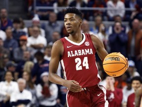 Alabama forward Brandon Miller brings the ball up during the first half of the team's NCAA college basketball game against Auburn on Feb. 11, 2023, in Auburn, Ala.