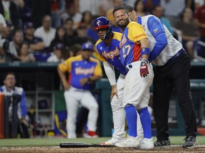 Venezuela second baseman Jose Altuve (27) reacts after getting hit by a pitch during the fifth inning against the USA at LoanDepot Park in Miami, Fla., March 18, 2023.