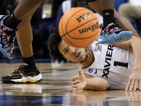 Xavier guard Desmond Claude eyes a loose ball during the second half of a first-round college basketball game Kennesaw State in the NCAA Tournament on Friday, March 17, 2023, in Greensboro, N.C.