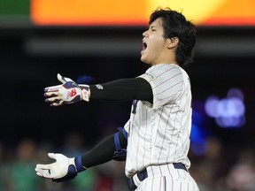 Japan's Shohei Ohtani celebrates after a double during the ninth inning of a World Baseball Classic game against Mexico, Monday, March 20, 2023, in Miami.