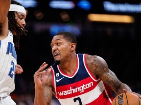 Mar 21, 2023; Orlando, Florida, USA; Washington Wizards guard Bradley Beal (3) dribbles the ball past Orlando Magic guard Markelle Fultz (20) during the second half at Amway Center.