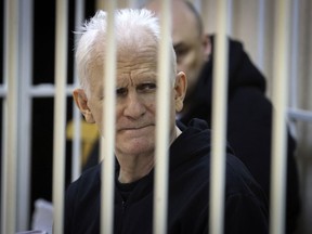 Ales Bialiatski, the head of Belarusian Vyasna rights group, sits in a defendants' cage during a court session in Minsk, Belarus, Jan. 5, 2023. A Belarusian court has sentenced Bialiatski, one of the winners of the 2022 Nobel Peace Prize, to 10 years in prison.
