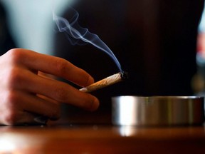 A visitor smokes a cannabis joint in a coffeeshop in Breda, Netherlands, March 1, 2023.