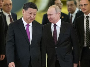 Chinese President Xi Jinping, left, and Russian President Vladimir Putin enter a hall for talks in the Kremlin in Moscow, Russia, June 5, 2019.