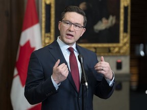 Conservative Leader Pierre Poilievre responds to a reporter's question in the Foyer of the House of Commons, in Ottawa, Feb. 21, 2023.