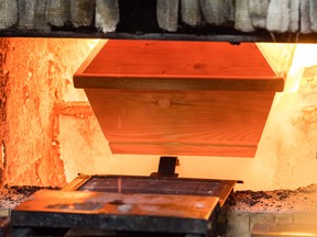 A coffin is moved for cremation into the furnace at a crematorium on January 13, 2021.
