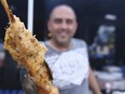 A cook makes souvlaki at the Fantasia Bouzouki Lounge during the Taste of the Danforth on Aug. 6, 2016. Sun/Postmedia Network