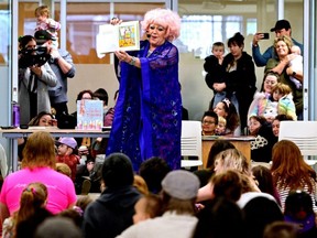 Conni Smudge reads a story to a crowd during Drag Queen Story Time at the Coquitlam City Centre library in Coquitlam, B.C., Jan. 14, 2023.