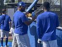 Edwin Encarnacion (middle) talks shop around the batting cage during Spring Training in Dunedin, Fla.