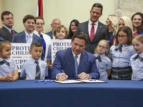 Florida Gov. Ron DeSantis signs the Parental Rights in Education bill at Classical Preparatory school on March 28, 2022, in Shady Hills, Fla.