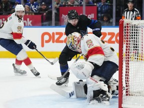 Florida Panthers goaltender Alex Lyon (34) stops Toronto Maple Leafs forward Calle Jarnkrok (19) as Panthers defenceman Aaron Ekblad (5) looks on during second period NHL hockey action in Toronto on Wednesday, March 29, 2023.