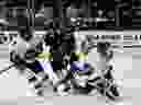 A Toronto Six forward Shiann Darkangelo (27) battles Minnesota Whitecaps' Amanda Boulier (28) in front of the Whitecaps goalie Amanda Leveille during the Isobel Cup Championship action in Tempe, Arizona on Sunday March 26, 2023.THE CANADIAN PRESS/HO-Premier Hockey Federation-Kate Free