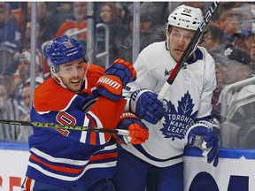 Mar 1, 2023; Edmonton, Alberta, CAN; Edmonton Oilers forward Derek Ryan checks Toronto Maple Leafs defensemen Jake McCabe during the first period at Rogers Place.