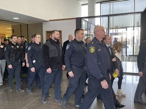 Dozens of officers walk through the lobby of the Leighton Criminal Courthouse following a hearing for Oak Lawn Police Officer Patrick O'Donnell, Wednesday, March 1, 2023.