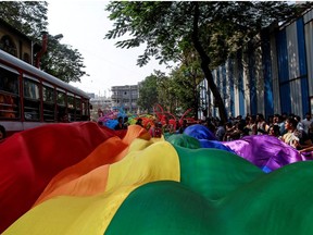 Participants hold a rainbow flag during gay pride parade, which is promoting gay, lesbian, bisexual and transgender rights, in Mumbai, January 31, 2015.