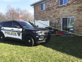 A Lafayette, Ind., Police Department SUV is parked behind an apartment in the 500 block of Westchester Lane in Romney Meadows Apartments in Lafayette, Ind., Tuesday, March 28, 2023. A 1-year-old child was shot and killed inside an apartment behind the police tape.