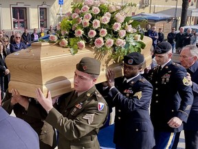 Soldiers from the U.S. Army Garrison Italy carry the coffin of Meri Mion at her funeral Thursday, March 9, 2023, in Grumolo delle Abbadesse, near Vicenza, northern Italy.