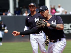 New York Yankees second baseman Gleyber Torres (25) throws the ball to first base during a game against the Toronto Blue Jays at George M. Steinbrenner Field.