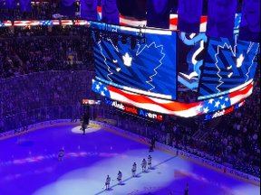 Maple Leafs fans sing the U.S. anthem after a mic malfunction ahead of the tilt against the Buffalo Sabres at Scotiabank Arena in Toronto on March 13, 2023.
