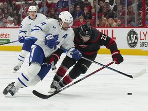 Toronto Maple Leafs centre Auston Matthews (34) skates after the puck against Carolina Hurricanes defenceman Brett Pesce (22) at PNC Arena.