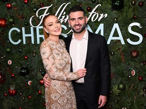 Lindsay Lohan and Bader Shammas attend Netflix's Falling For Christmas celebratory holiday fan screening with cast and crew on Nov. 9, 2022 in New York City.