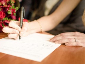 Signing the papers in a wedding ceremony.
