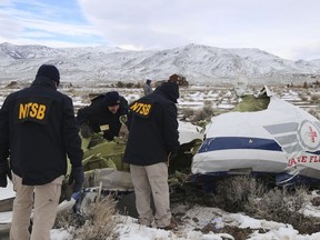 In this image provided by The National Transportation Safety Board, NTSB investigators document the wreckage of a Pilatus PC-12 airplane, a medical air transport flight operated by Guardian Flight, Feb. 26, 2023, in Dayton, Nev.