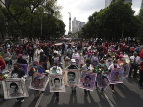 Relatives and classmates of the missing 43 Ayotzinapa college students march in Mexico City, Sept. 26, 2022, marking the anniversary of their disappearance.