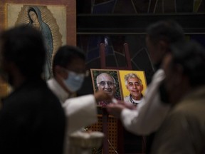 Worshipers partake of communion during a Mass to mourn the deaths of Jesuit priests Javier Campos and Joaquin Mora, at a church in Mexico City, June 21, 2022.